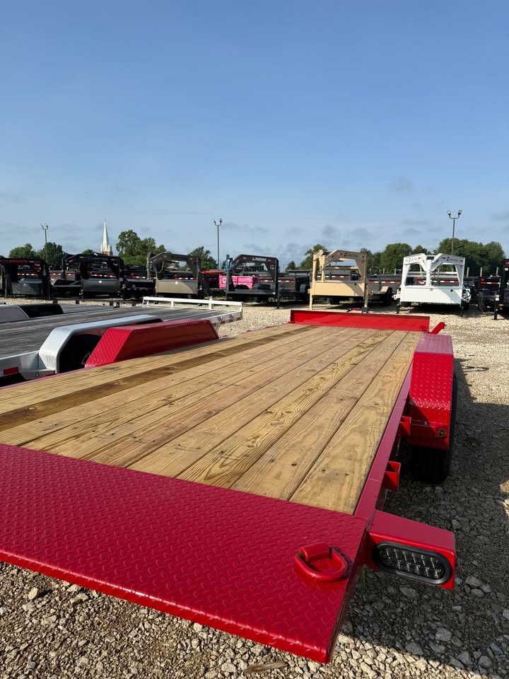 Rear deck view of a red Load Trail 83 in x 22 ft full fender tilt trailer with wood deck and full fenders
