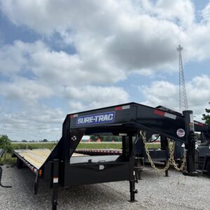Front view of a black Sure-Trac 102 x 40 gooseneck flatbed trailer with wood deck and tandem axles