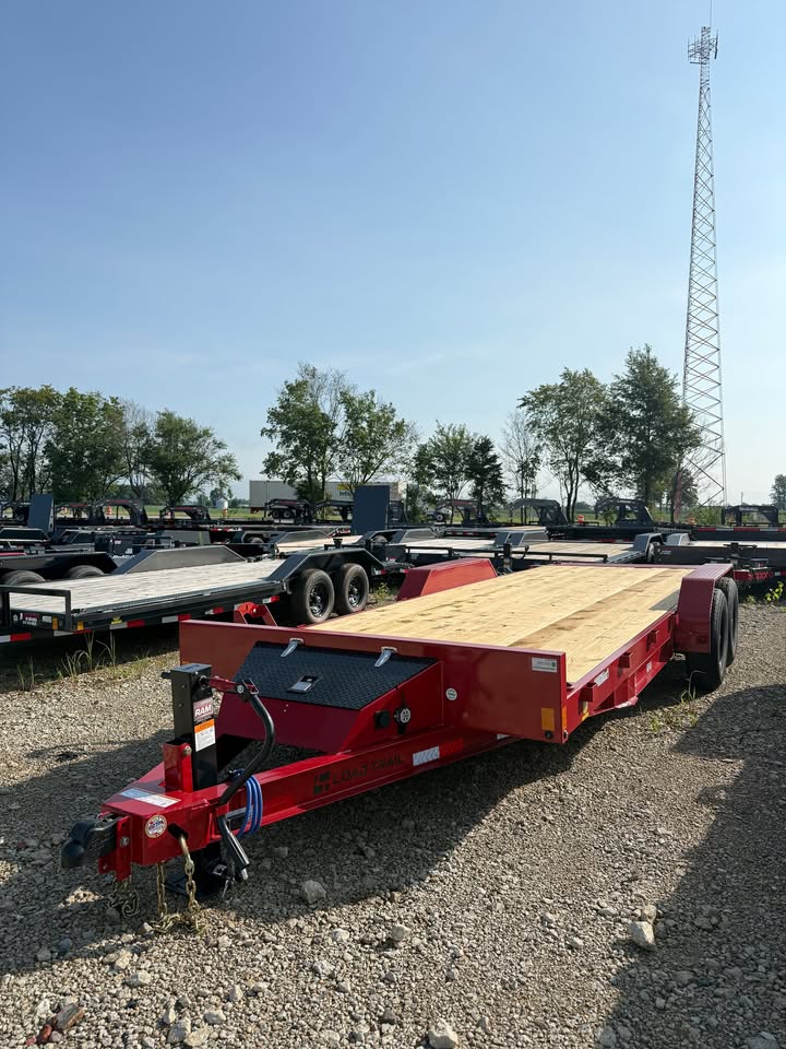 Front angled view of a red Load Trail 83 x 22 full fender tilt trailer with wood deck and tandem axles