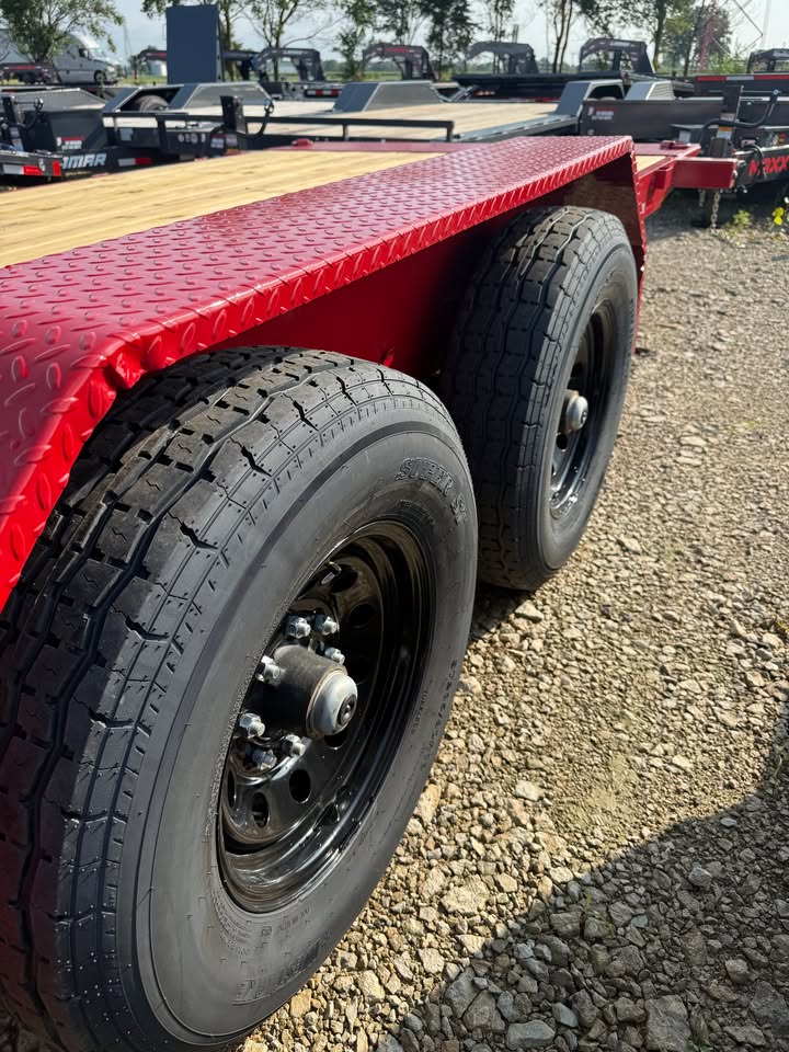 Close-up of the tandem axle wheels and red full fender on a Load Trail 83 in x 22 ft full fender tilt trailer
