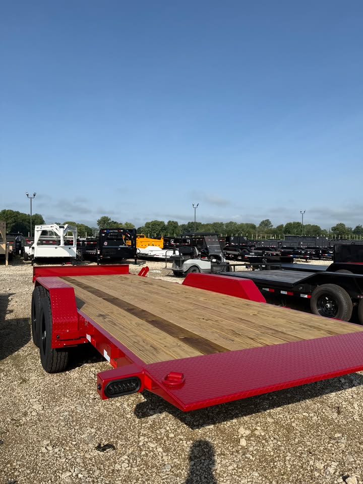 Rear view of a red Load Trail 83 in x 22 ft full fender tilt trailer with wood deck and tandem axles